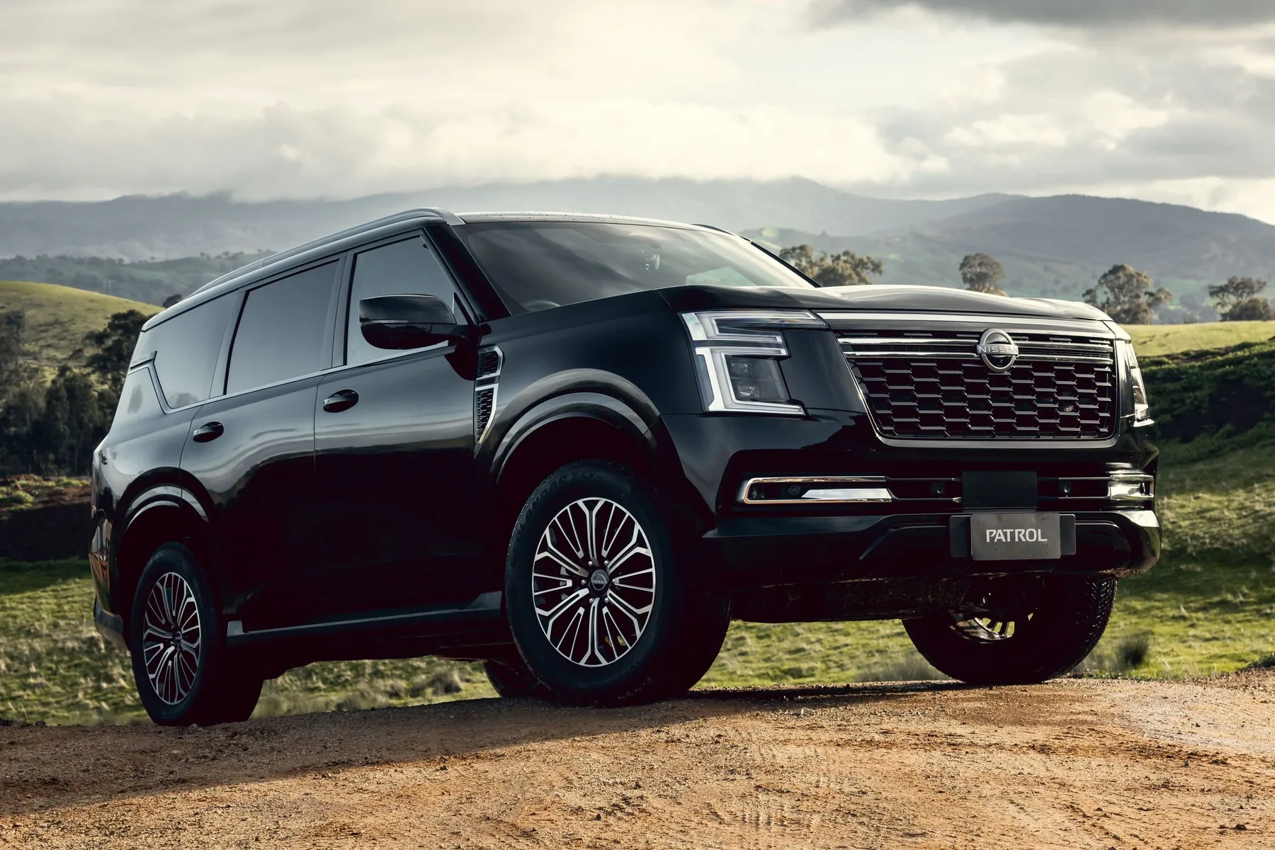 Black Nissan Patrol SUV parked on a country road